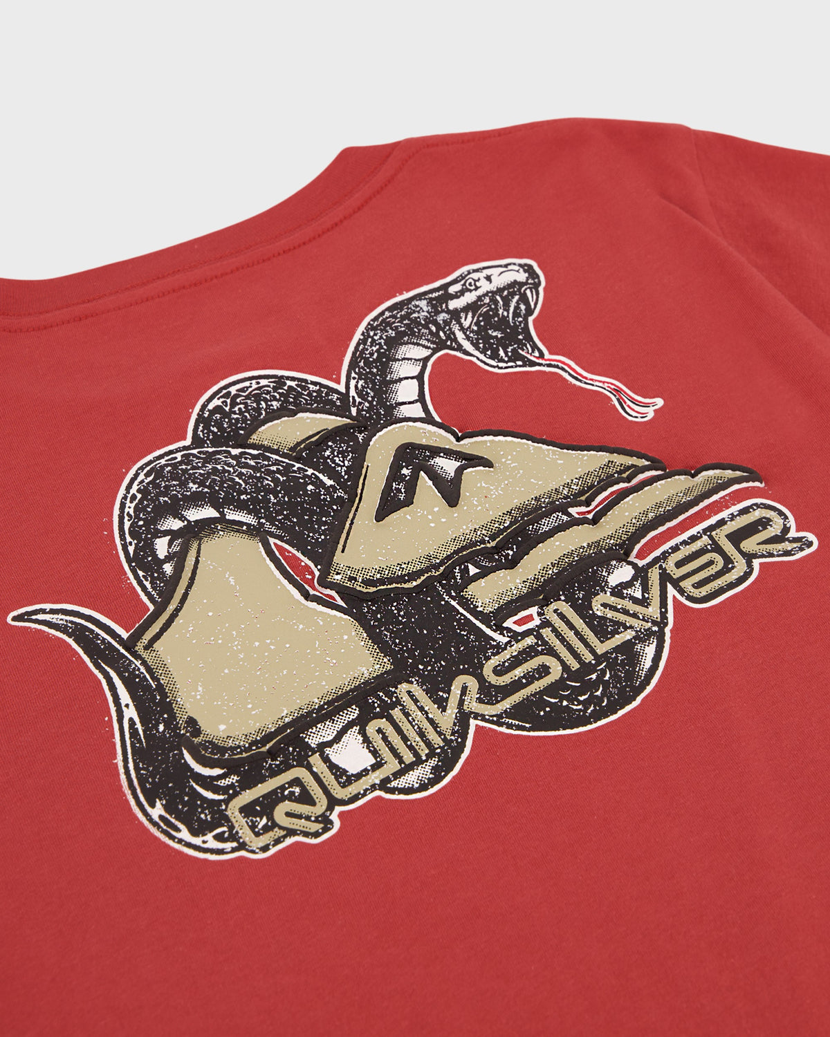 Red t-shirt with a snake and shoe graphic and 'Quiksilver' branding on a white background.