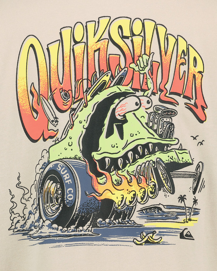 Quiksilver surfboard with shark design and colorful text on a beige background