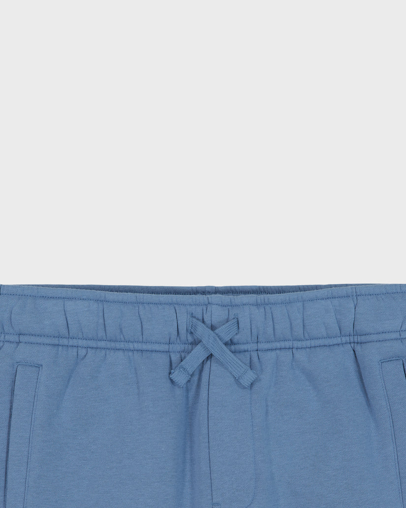 Blue pants with a drawstring on a light gray background