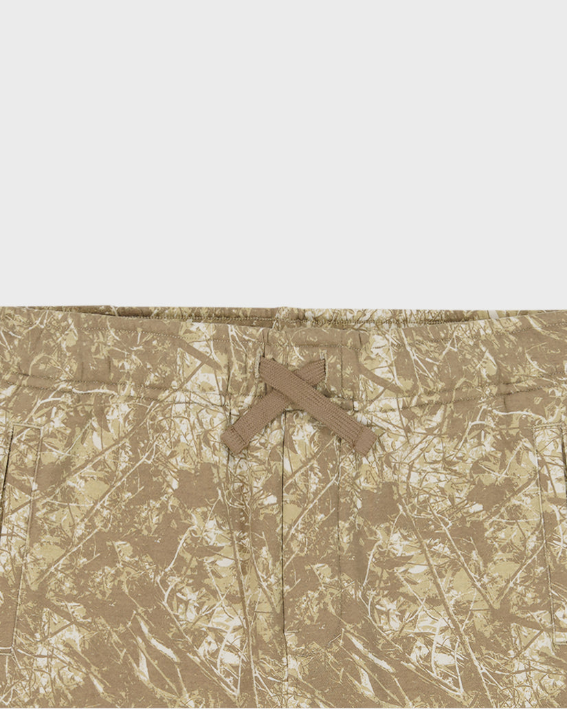 Camouflage pattern with a cross symbol on a textured beige background