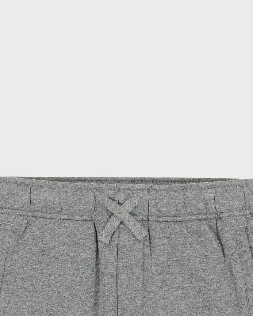 Close-up of gray sweatpants with a drawstring on a light gray background