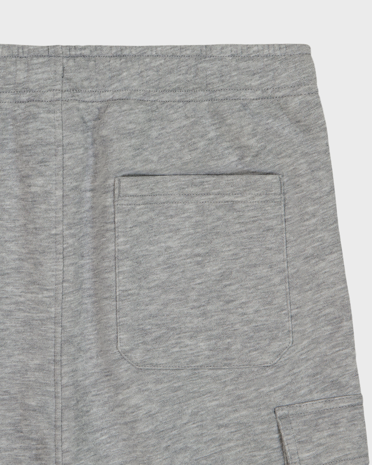 Close-up of black pants with a button on a white background