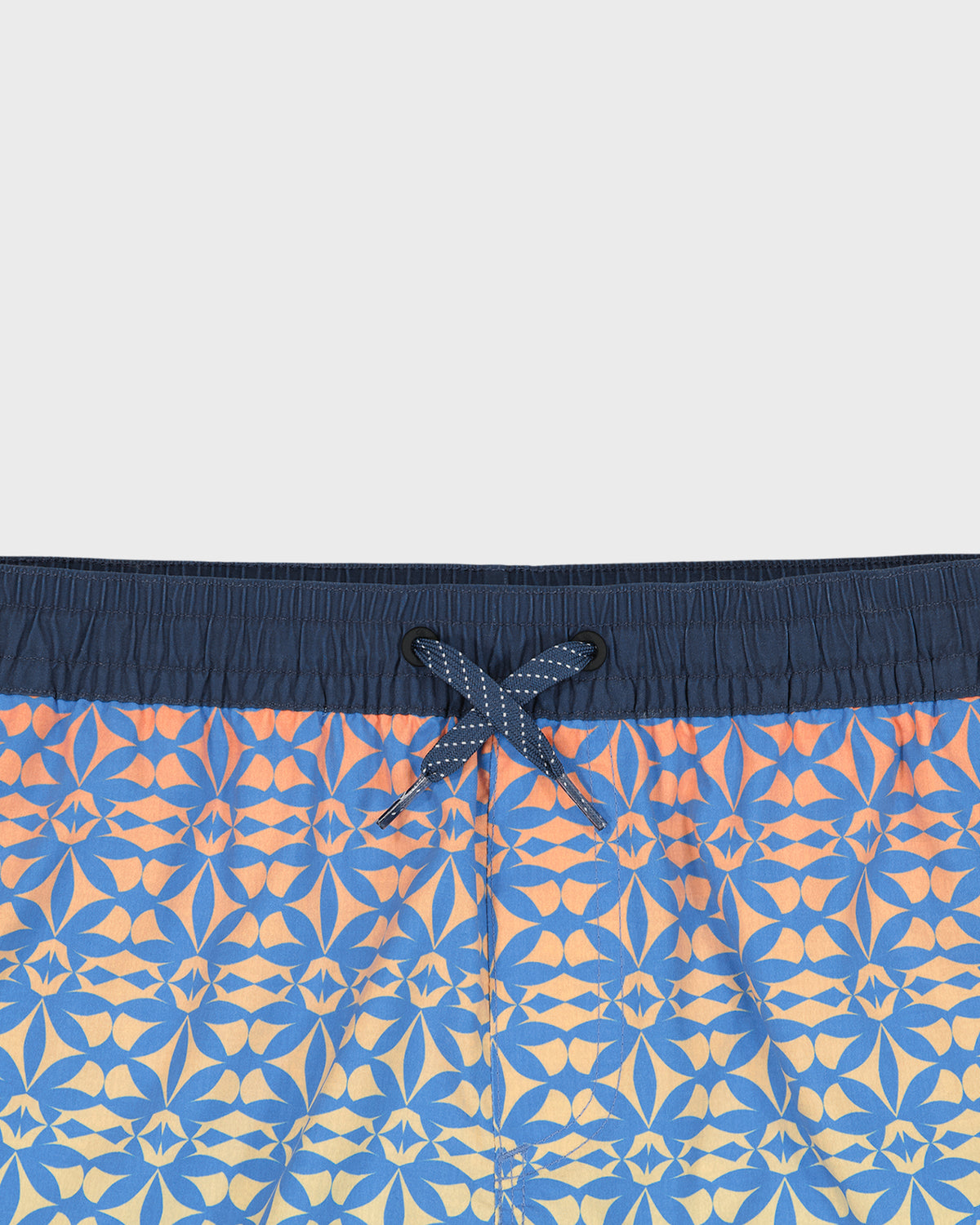 Blue and orange patterned swim shorts with a drawstring on a white background