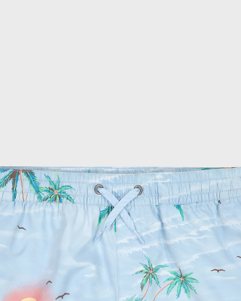 Close-up of a blue swimsuit with palm tree pattern on a white background