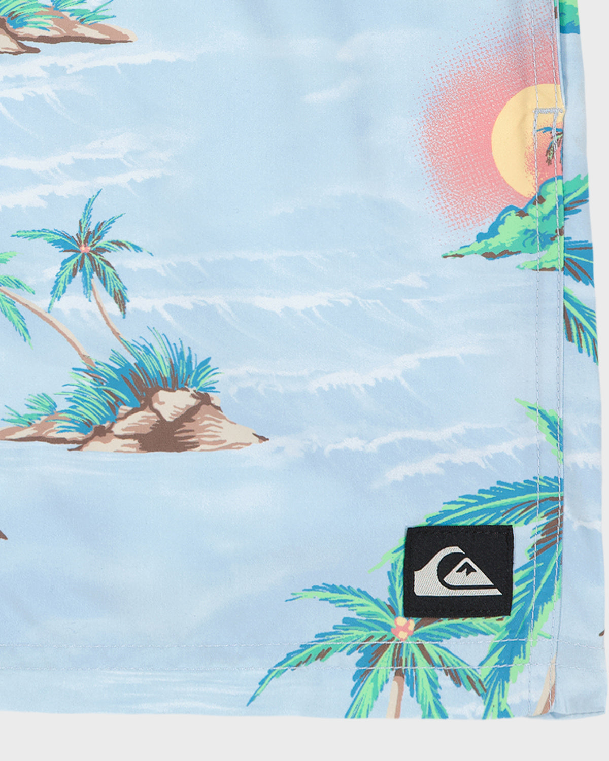 Tropical beach scene with palm trees and a sunset on a blue background, featuring a Quiksilver logo.