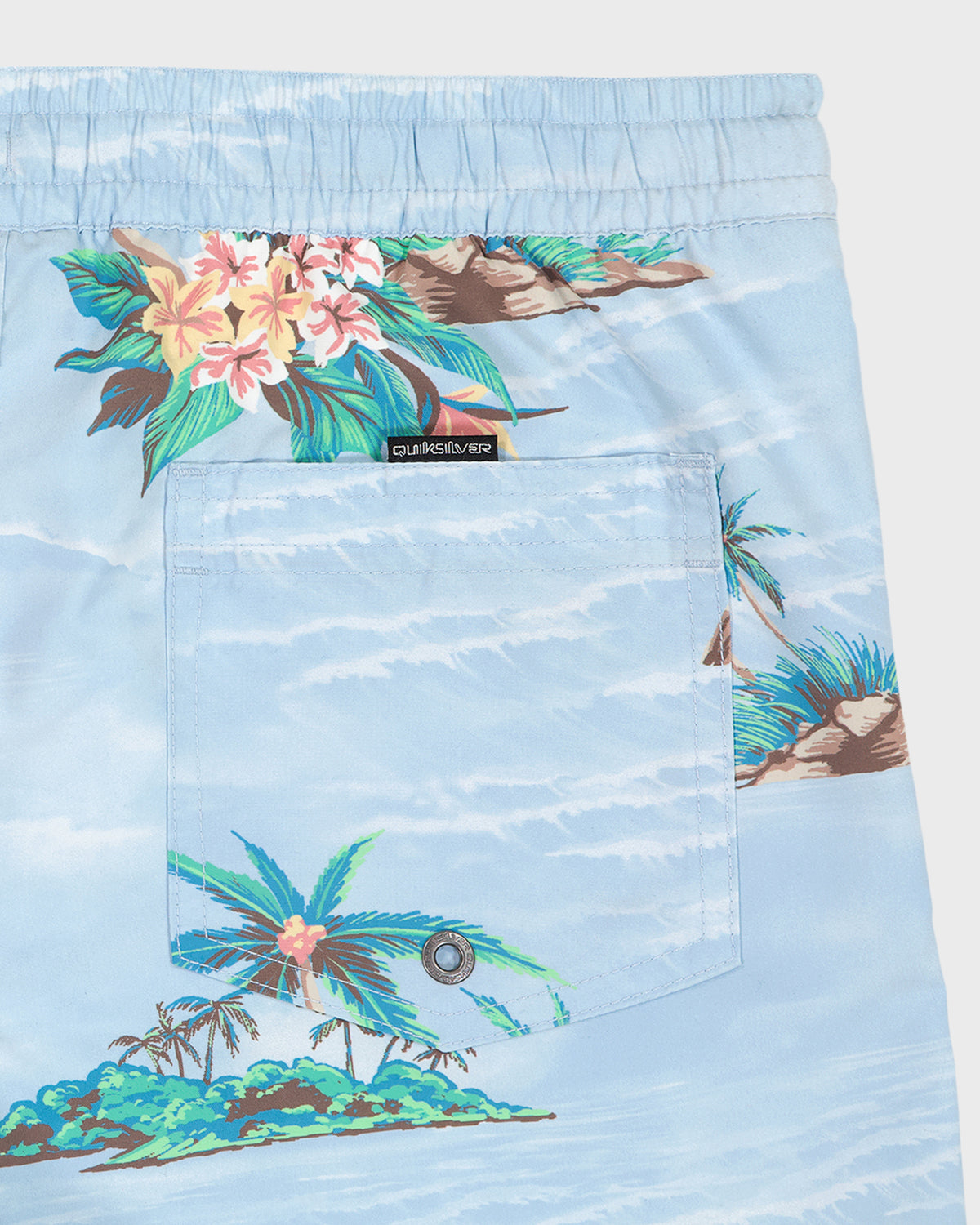 Light blue shorts with tropical island design and brand label on a white background
