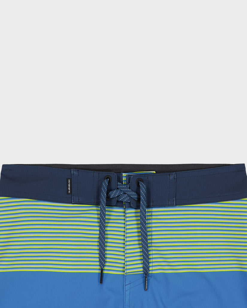 Blue and green striped swim shorts with a drawstring on a light gray background