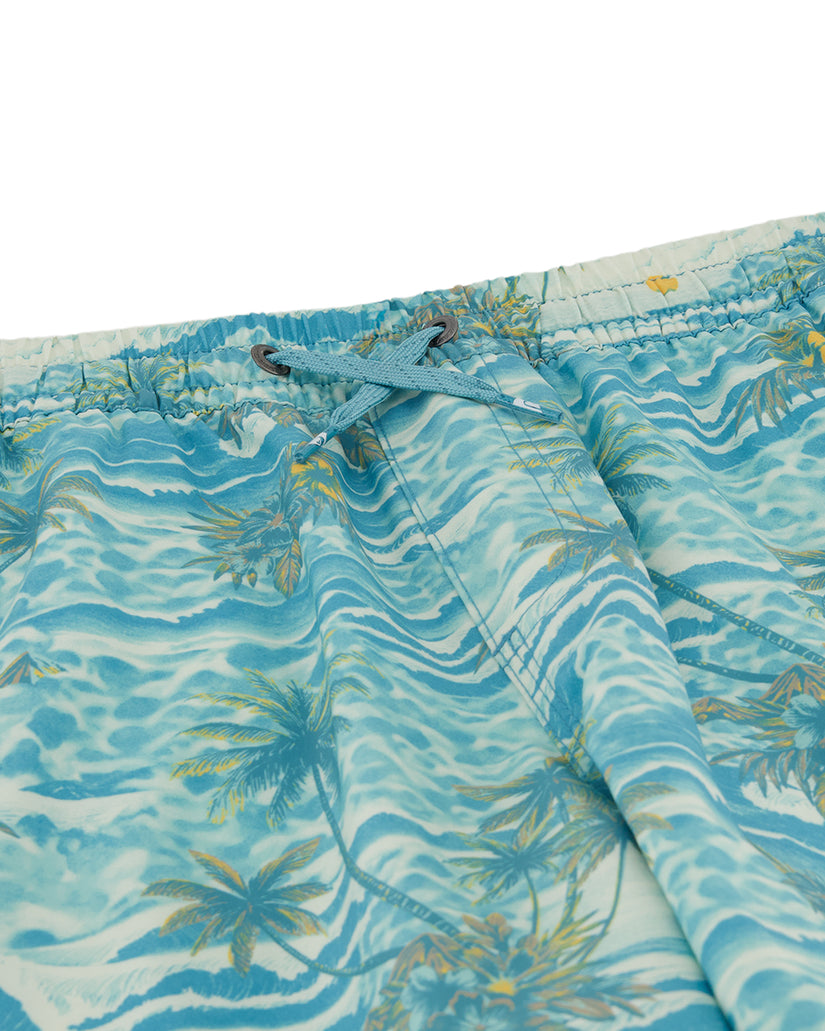 Tropical patterned shorts with blue and green colors on a white background