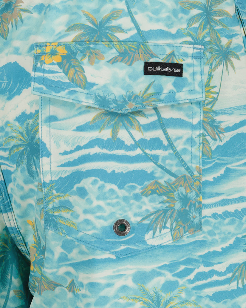 Blue tropical patterned shirt with palm trees and ocean waves on a white background.